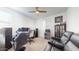 The bedroom shows a ceiling fan, a workspace, a modern chair and a leather couch at 14420 W Faye Way, Surprise, AZ 85387