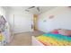 Bright bedroom showcasing a rainbow bedspread and double door closet at 14420 W Faye Way, Surprise, AZ 85387