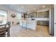 Well-lit kitchen with stainless steel appliances, an island with seating, and gray cabinets at 14420 W Faye Way, Surprise, AZ 85387