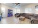 Cozy living room features a comfortable sectional, large windows, and a decorative cabinet at 14420 W Faye Way, Surprise, AZ 85387