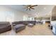 Relaxing living room showcasing a large sectional, neutral flooring, and plenty of natural light at 14420 W Faye Way, Surprise, AZ 85387