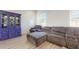 Well-lit living room boasting a plush sectional sofa, lots of natural light, and decorative shelving at 14420 W Faye Way, Surprise, AZ 85387