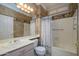 Charming bathroom featuring a tub with shower, vanity, decorative wallpaper and ample lighting at 14432 W Robertson Dr, Sun City West, AZ 85375