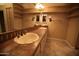 Bathroom featuring double sinks, tile countertops, and plentiful storage space at 14432 W Robertson Dr, Sun City West, AZ 85375