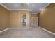 Bright, carpeted primary bedroom with an arched entryway to the ensuite bathroom at 14432 W Robertson Dr, Sun City West, AZ 85375