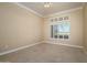 Bright bedroom with neutral walls, plush carpeting, and a window with shutters for natural light at 14432 W Robertson Dr, Sun City West, AZ 85375