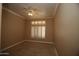 Bedroom showcasing neutral walls, plush carpeting, and bright shutters at 14432 W Robertson Dr, Sun City West, AZ 85375