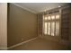 Bedroom featuring built-in shelves, bright shutters, and plush carpeting at 14432 W Robertson Dr, Sun City West, AZ 85375