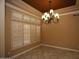 Elegant dining room featuring custom window shutters and an ornate chandelier at 14432 W Robertson Dr, Sun City West, AZ 85375