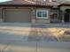 Home featuring desert landscaping, a paver driveway, and solar panels on the roof at 14432 W Robertson Dr, Sun City West, AZ 85375