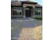 Inviting front entrance with a brick walkway and landscaped features creating curb appeal at 14432 W Robertson Dr, Sun City West, AZ 85375