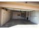 Spacious garage with ample storage cabinets, built-in shelving, and room for multiple vehicles at 14432 W Robertson Dr, Sun City West, AZ 85375