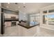 Spacious kitchen features a central island, stainless appliances, and plantation shutters at 14432 W Robertson Dr, Sun City West, AZ 85375