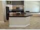 Spacious kitchen island with a dark countertop and ample storage at 14432 W Robertson Dr, Sun City West, AZ 85375