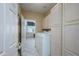 Well-organized laundry room featuring ample cabinetry, modern appliances, and a door to the garage at 14432 W Robertson Dr, Sun City West, AZ 85375