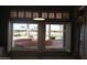 Bright living room featuring custom shutters and a beautiful view of the outdoor patio and community golf course at 14432 W Robertson Dr, Sun City West, AZ 85375