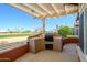 Inviting outdoor kitchen with a built-in grill, perfect for entertaining and enjoying golf course views at 14432 W Robertson Dr, Sun City West, AZ 85375