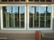 Well-lit windows with white frames and views of the outdoor landscape and a glimpse of nearby houses at 14432 W Robertson Dr, Sun City West, AZ 85375