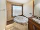 Bathroom showcasing jetted tub surrounded by marble and granite at 14645 S 25Th Pl, Phoenix, AZ 85048