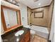 Stylishly updated bathroom featuring a granite countertop, tiled shower/tub, and modern fixtures at 14645 S 25Th Pl, Phoenix, AZ 85048