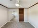 Carpeted bedroom featuring a ceiling fan, mirrored closet doors and built-in shelves and drawers at 14645 S 25Th Pl, Phoenix, AZ 85048