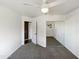 Well-lit bedroom with ceiling fan, mirrored closet doors, and neutral carpet at 14645 S 25Th Pl, Phoenix, AZ 85048