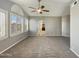 Spacious carpeted bedroom with ceiling fan and large windows with shutters at 14645 S 25Th Pl, Phoenix, AZ 85048