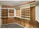 Walk-in closet with custom built in shelves and wooden paneling at 14645 S 25Th Pl, Phoenix, AZ 85048