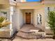 Welcoming front entrance featuring a solid wood door, stone steps, and a well-manicured garden at 14645 S 25Th Pl, Phoenix, AZ 85048