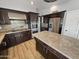 Gourmet kitchen with stainless steel appliances, granite counters, custom cabinetry, and a center island at 14645 S 25Th Pl, Phoenix, AZ 85048