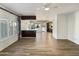 Open living area with wood flooring, white trim, recessed lighting, and a view into the kitchen at 14645 S 25Th Pl, Phoenix, AZ 85048