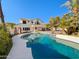 Inviting backyard featuring a sparkling pool, lush landscaping, and an outdoor seating area at 14645 S 25Th Pl, Phoenix, AZ 85048