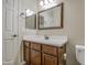 Bathroom featuring a single sink vanity with dark wood cabinets and a white countertop, plus a toilet at 1541 W Crape Rd, San Tan Valley, AZ 85140