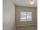 Neutral carpeted bedroom with a ceiling fan and window with blinds offering peaceful, adjustable lighting at 1541 W Crape Rd, San Tan Valley, AZ 85140