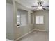 Cozy bedroom with neutral paint, a ceiling fan, and an open window to the bathroom at 1541 W Crape Rd, San Tan Valley, AZ 85140