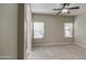 Bright and spacious bedroom with neutral colors and two windows at 1541 W Crape Rd, San Tan Valley, AZ 85140