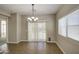 Inviting dining area with tile floors, chandelier lighting, and sliding door access to the outdoors at 1541 W Crape Rd, San Tan Valley, AZ 85140