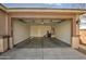 A spacious garage with a water heater, door to interior, and fluorescent lighting at 1541 W Crape Rd, San Tan Valley, AZ 85140