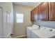 Laundry area with top loading washer, dryer and cabinets above for storage space at 1541 W Crape Rd, San Tan Valley, AZ 85140