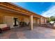 Inviting covered patio with decorative stone flooring and outdoor seating at 15492 W Whitton Ave, Goodyear, AZ 85395