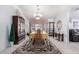 Formal dining room with a chandelier, large windows, and elegant furniture at 15492 W Whitton Ave, Goodyear, AZ 85395