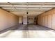 Spacious garage with built-in storage cabinets and overhead lighting at 15492 W Whitton Ave, Goodyear, AZ 85395