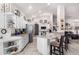 Open kitchen with white cabinetry, a breakfast bar, tile flooring, and stainless steel appliances at 15492 W Whitton Ave, Goodyear, AZ 85395