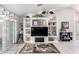 Bright and airy living room featuring tile flooring, built-in shelving, and decorative accents at 15492 W Whitton Ave, Goodyear, AZ 85395