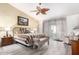 Cozy main bedroom with a ceiling fan, a bench, and a sliding glass door at 15492 W Whitton Ave, Goodyear, AZ 85395