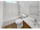 A clean, well-lit bathroom featuring a shower-tub combo, toilet, and a sink with a wooden vanity at 16370 W Rimrock St, Surprise, AZ 85388