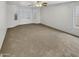 Large bedroom featuring carpeted floors, plantation shutters, and ample natural light at 16370 W Rimrock St, Surprise, AZ 85388