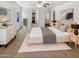 Bright main bedroom showcasing neutral tones, soft carpet, ceiling fan, and ample natural light at 16370 W Rimrock St, Surprise, AZ 85388