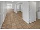 Hallway featuring tile floors, neutral paint, open layout and an abundance of natural light at 16370 W Rimrock St, Surprise, AZ 85388