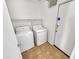 Functional laundry room with shelving, tile floors, and washer/dryer hookups at 16370 W Rimrock St, Surprise, AZ 85388